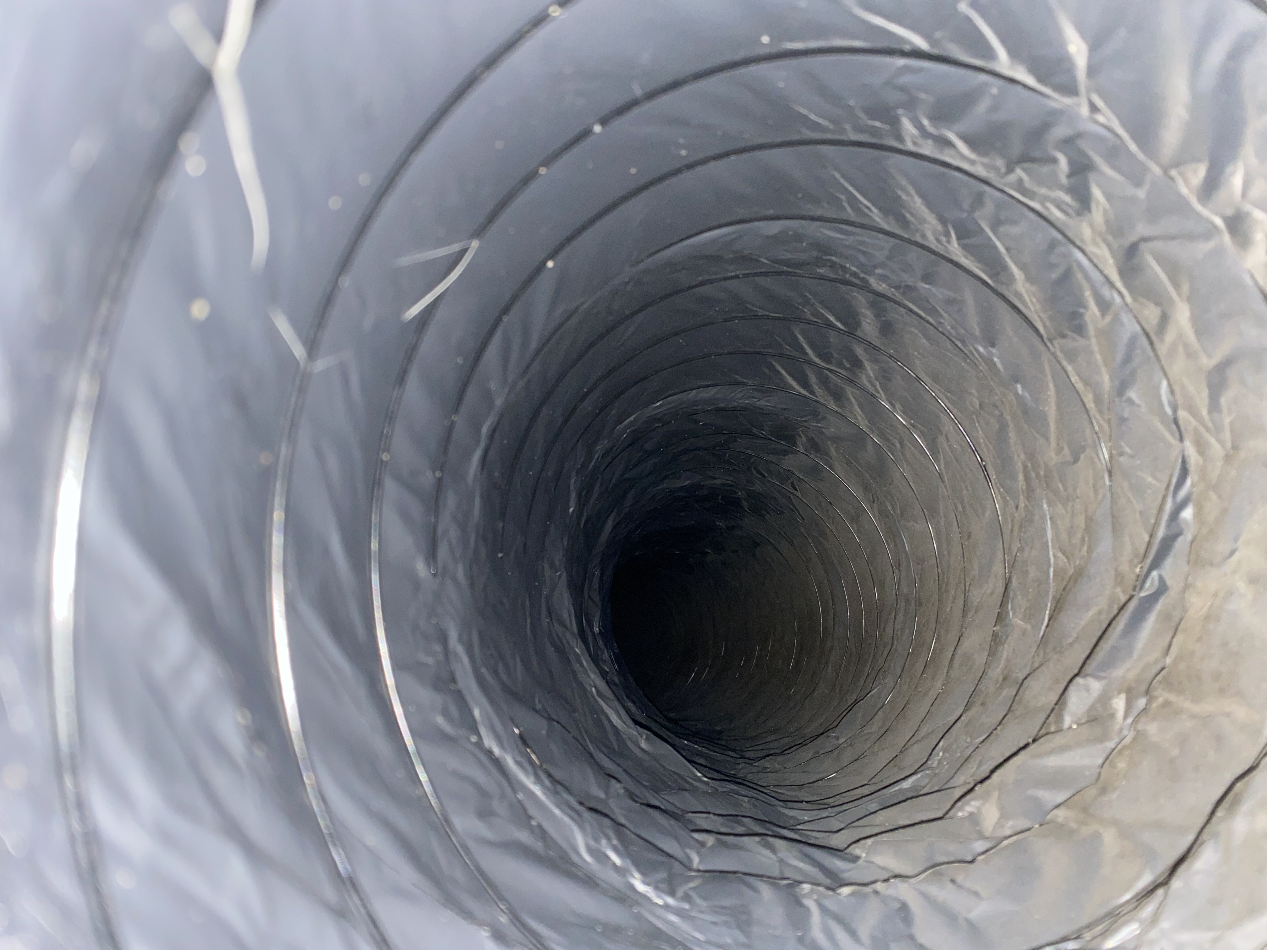 Heavily dust-laden flexible duct interior before cleaning, Golden Gate, FL